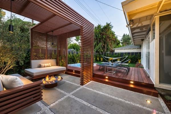 215404959-crop-terrace-with-the-wooden-slats-floor-tiles-and-table-with-fireplace